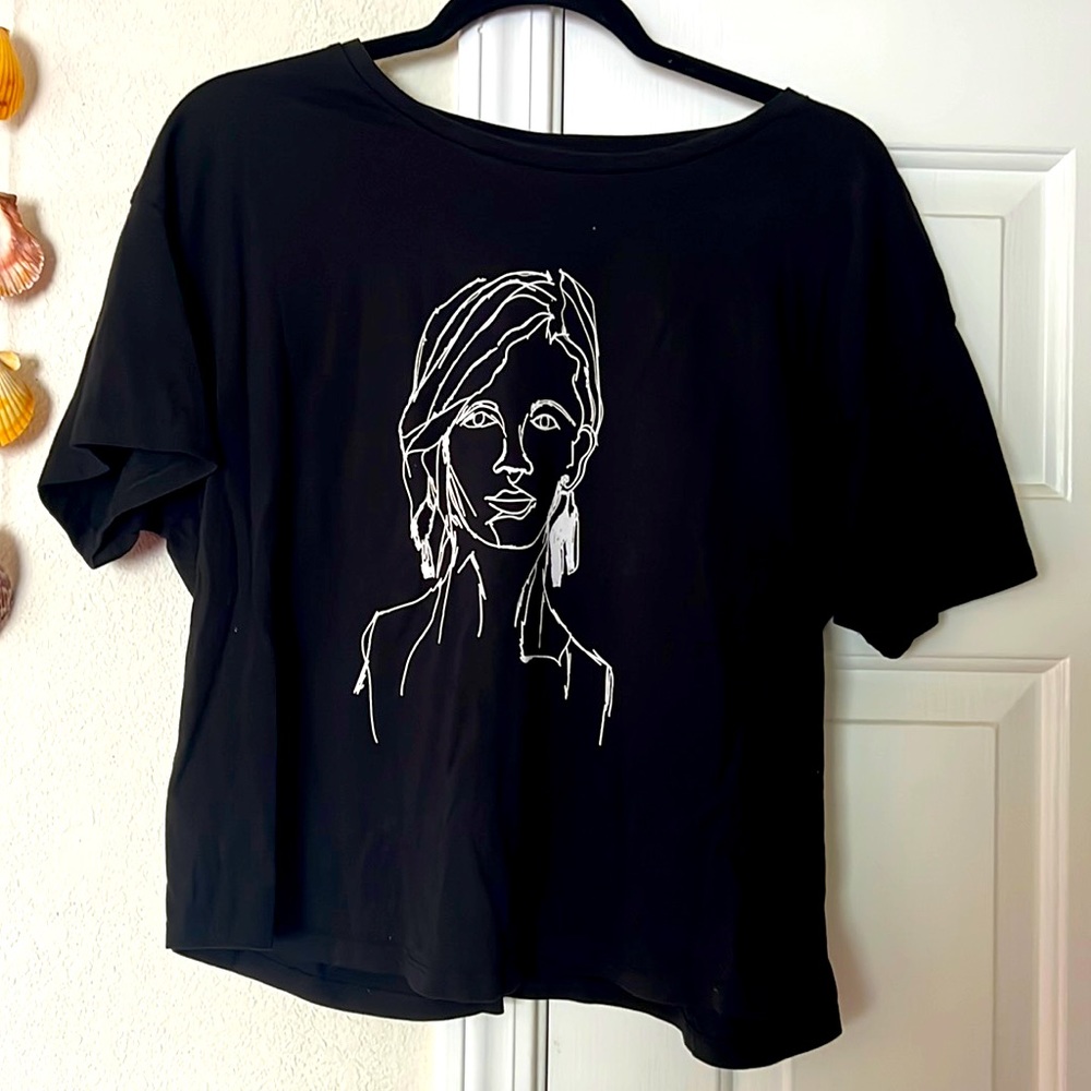 A black tee with a face on it.